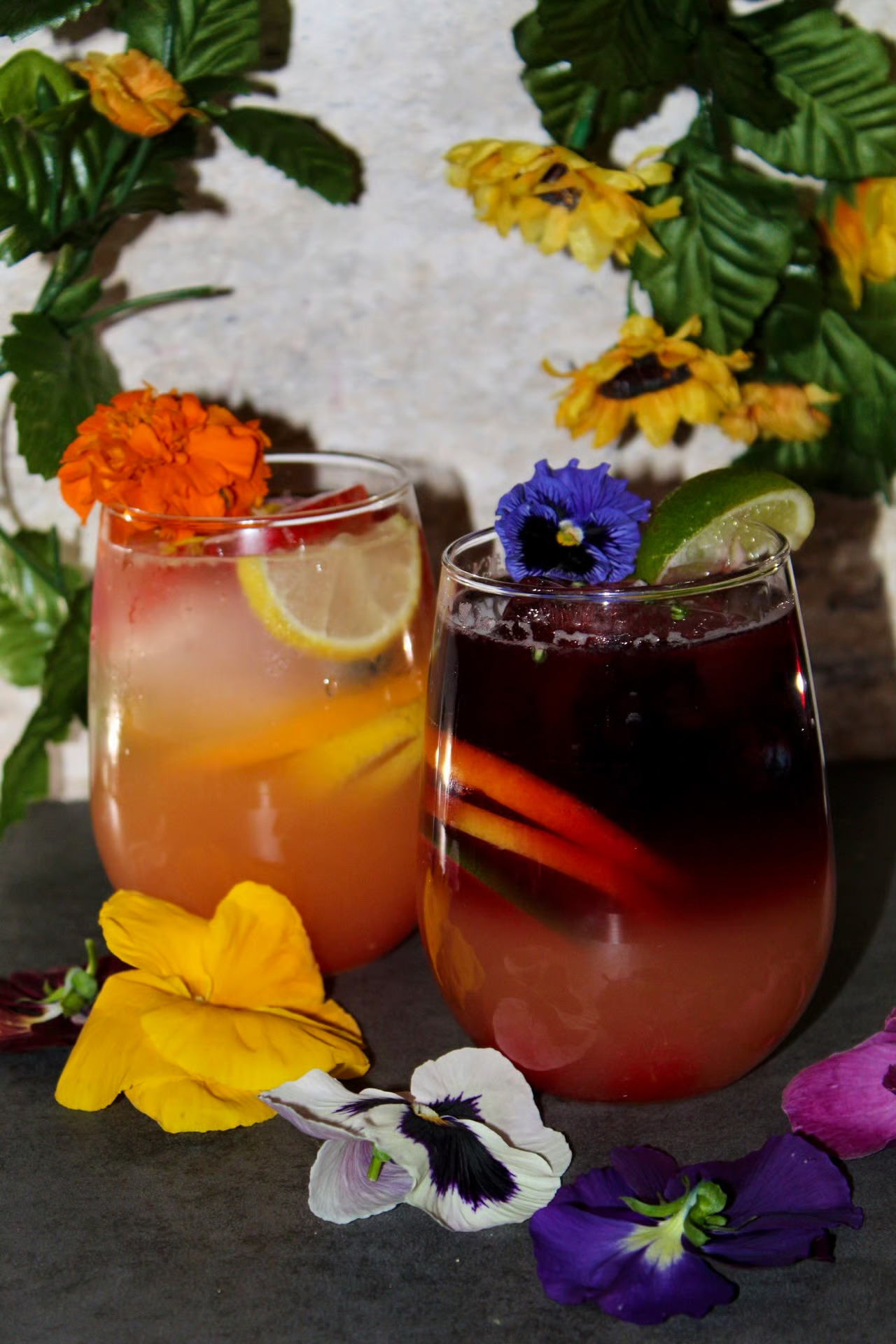 Colorful cocktail drinks with floral garnish at Moustache Lounge