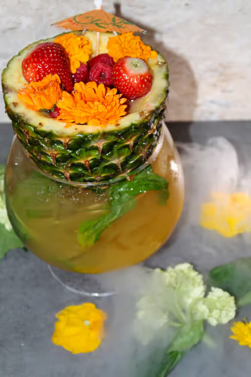 Tropical cocktail in a pineapple glass at Moustache Lounge